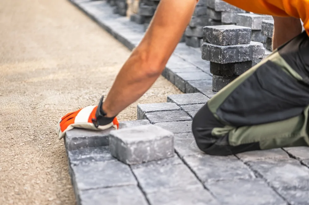 Interlink Paving team installing a grey block on a Warrington Home