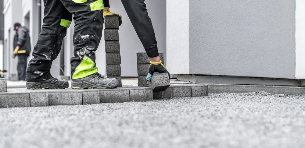 Interlink paving team laying blocks for new block paving driveway in Liverpool